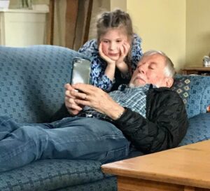 grandparent and girl on iphone