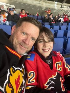 Son and dad at a Flames hockey game -- respond not react