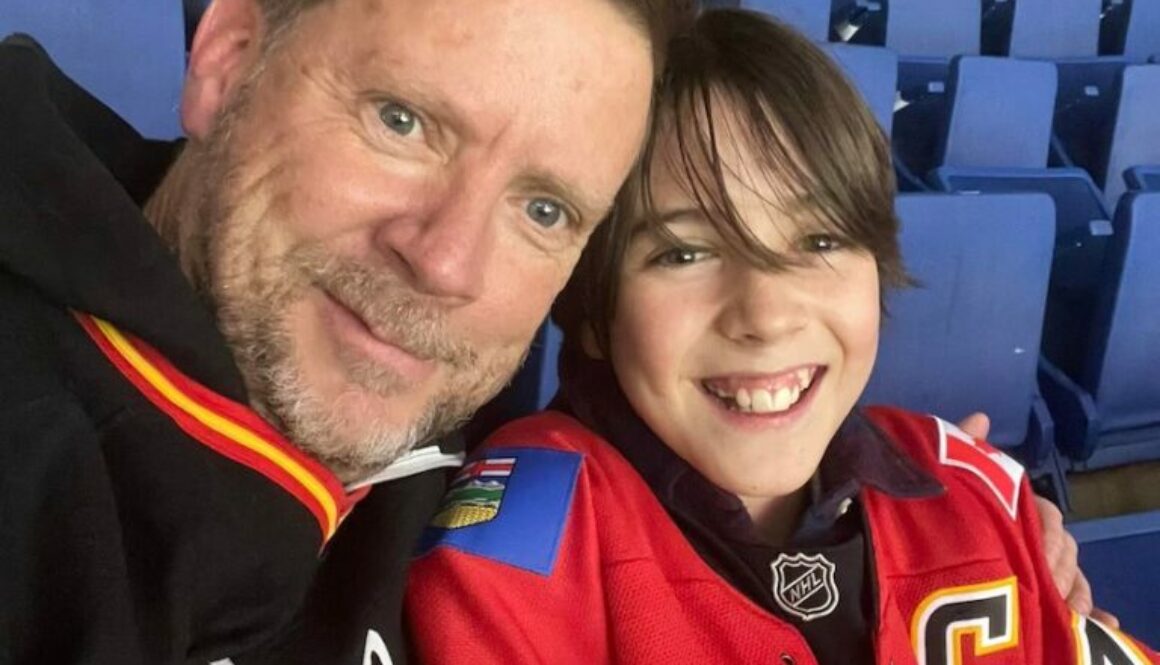 Son and dad at a Flames hockey game -- respond not react
