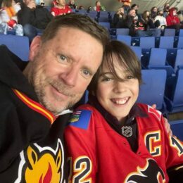 Son and dad at a Flames hockey game -- respond not react