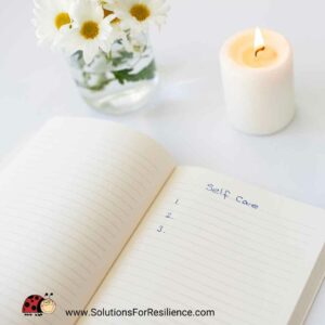 journal & flowers for self-compassion