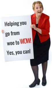 Patricia with sign that reads "Helping you go from woe to WOW!