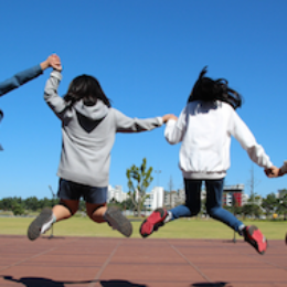 four youth jumping for joy